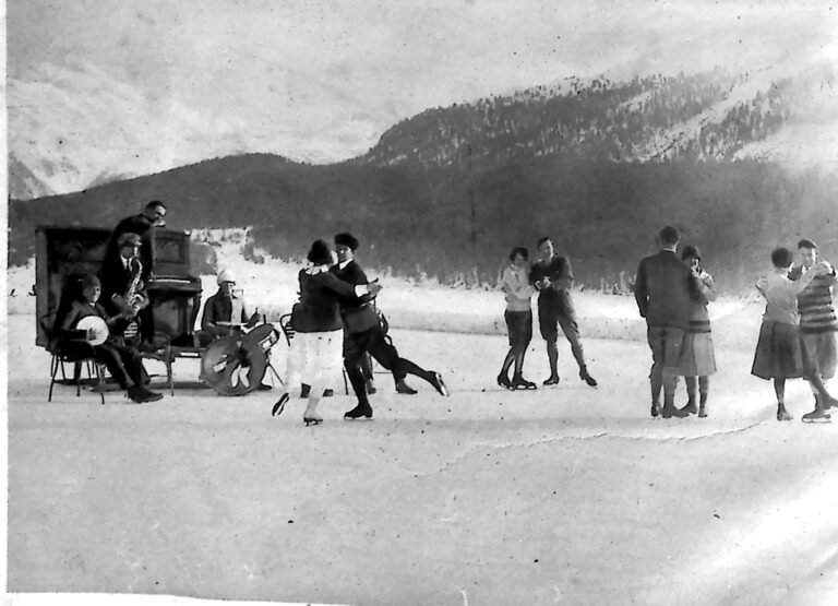 Pary tańczące na zamarzniętym jeziorze w St. Moritz przy akompaniamencie jazzbandu grającego na lodzie, w tle ośnieżone góry. Fotografia z 1926 r.